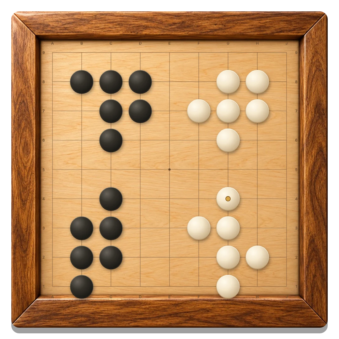 The playable wooden 9 by 9 Go board with black and ivory stones forming groups around the corners